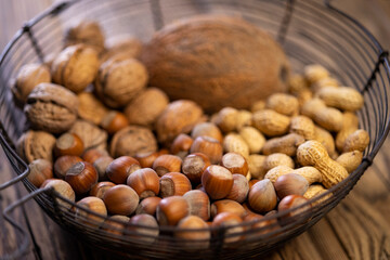 different kinds of nuts on a wooden background
