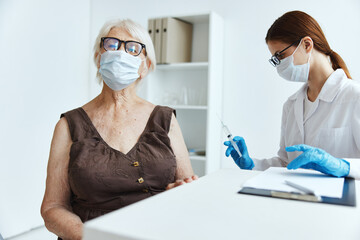 elderly woman wearing a medical mask in the hospital for vaccinations covid passport