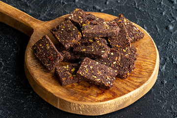 Hazelnut and pistachio cookies on dark background