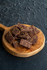 Hazelnut and pistachio cookies on dark background