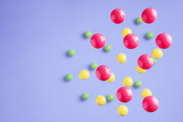 Colorful balls flowing upwards on purple background. .Abstract background with bright balls.