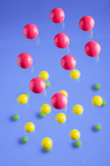 Fototapeta na wymiar Colorful balls flowing upwards on purple background. .Abstract background with bright balls.