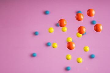 Colorful balls flowing upwards on pink background. .Abstract background with bright balls.