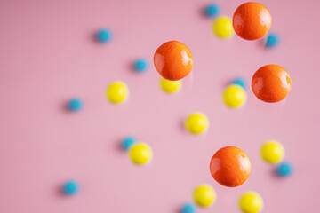 Colorful balls flowing upwards on pink background. .Abstract background with bright balls.
