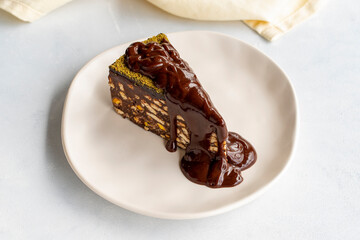 Mosaic cake with chocolate sauce on a white background
