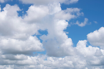 White clouds against a blue sky. Good daylight weather copy space for text