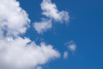 White clouds against a blue sky. Good daylight weather copy space for text