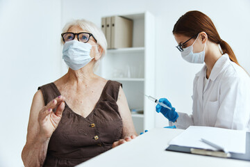 old woman wearing medical mask in the hospital for vaccinations covid passport
