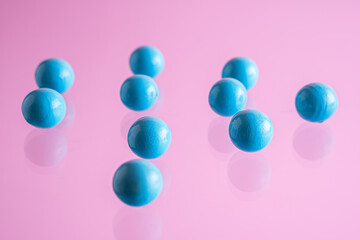 Blue balls on pink background. .Abstract background with bright balls