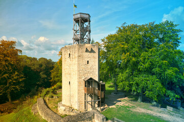 more than 1000 years old castle ruins with destroyed walls and a wooden viewing platform