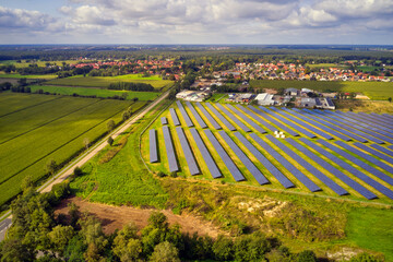 Fototapeta na wymiar Aerial view of a large solar plant with solar panels on the edge of a village in Germany