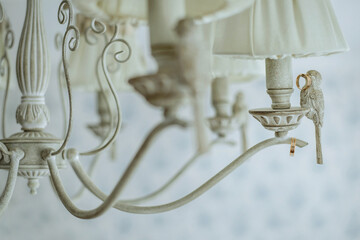 wedding rings hang on a beautiful wooden chandelier, light delicate photo