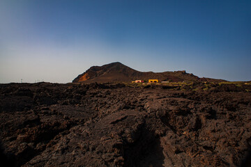 Road with dry stone wall . The Monte Nero Volcano on the background. Linosa