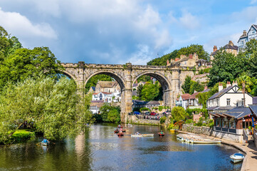 Fototapeta na wymiar A view along the River Nidd towards the viaduct in the town of Knaresborough in Yorkshire, UK in summertime