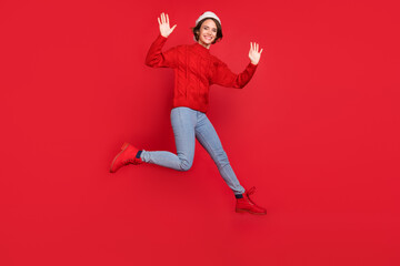 Fototapeta na wymiar Full length body size photo woman in headwear jumping waving hand on meeting isolated vivid red color background