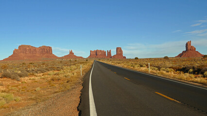 Fototapeta na wymiar Monument Valley road with towering rock formations, popular western movies filming location and tourist place, Utah and Arizona, United States