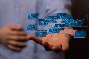 Hand holding using mobile phone with email icon on screen. Concept of business communication