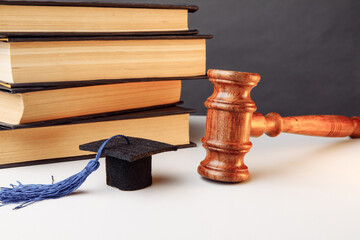 Law or education concept. Books with graduation cap and wooden gavel