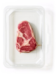 Raw steak packed for market isolated on white, from above