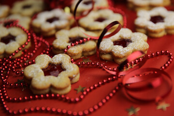 Christmas cookies and decorations on a red background.