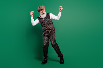 Photo of carefree funky gentleman clubbing enjoy weekend wear cap striped suit scarf on green color...