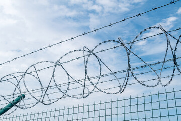 Barbed wire on the top of fence.