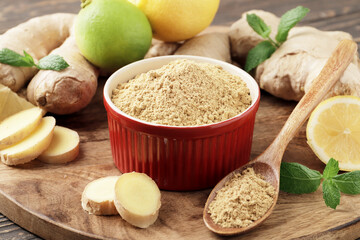 A bowl full of dry ginger, with fresh ginger, lemon and mint.