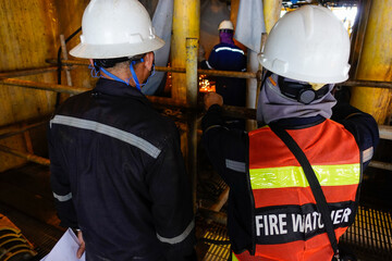 Fire watcher watch welder weld gas pipe casing for stop work in case of gas explosive, working in...