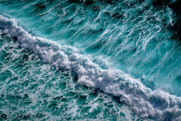 Aerial view to seething waves with foam. Waves of the sea meet each other during high tide and low tide - 460136098