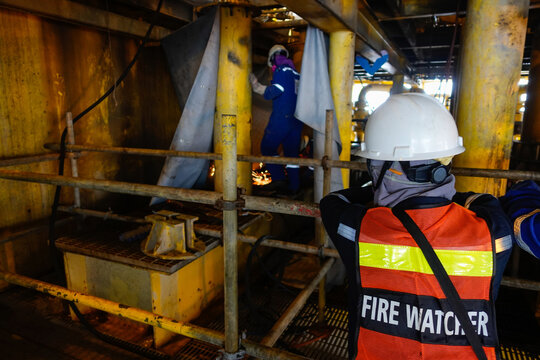 Fire Watcher Watch Welder Weld Gas Pipe Casing For Stop Work In Case Of Gas Explosive, Working In Offshore Oil And Gas Platform.