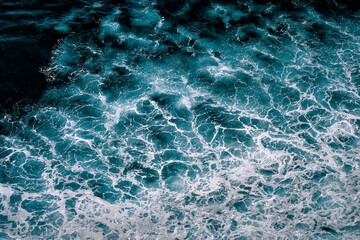 Aerial view to seething waves with foam. Waves of the sea meet each other during high tide and low tide - 460136443