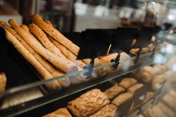 Details from modern bakery. Different delicious bakery products on shelf's.