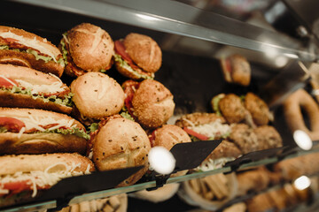 Details from modern bakery. Different delicious bakery products on shelf's.