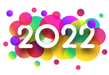 2022 white sign over colourful confetti.