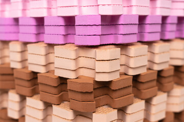 Multi-colored children's rugs in a stack.
