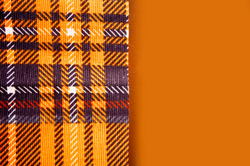 autumn colored napkin on orange background. Top view. Copy space.