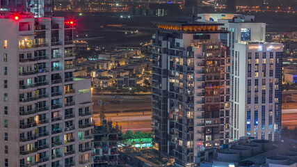 Fototapeta na wymiar Luxury houses and villas near canal with towers aerial all night timelapse in Business Bay, Dubai, United Arab Emirates.