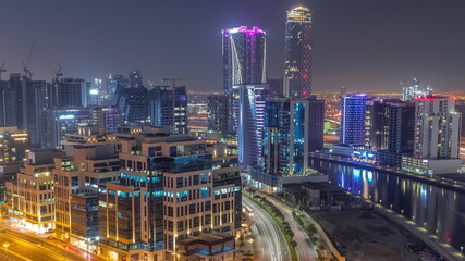Fototapeta na wymiar Skyscrapers at the Business Bay aerial all night timelapse in Dubai, United Arab Emirates