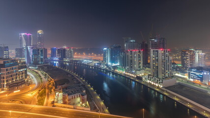 Modern city architecture in Business bay district before sunrise. Panoramic view of Dubai's skyscrapers all night timelapse