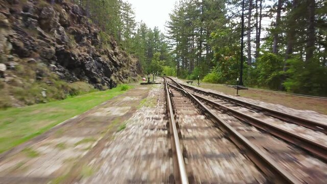 Front view of a moving train on old railway with slight moving to the sides.