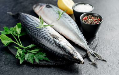 raw mackerel with spices on a stone background