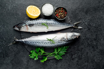 raw mackerel with spices on a stone background
