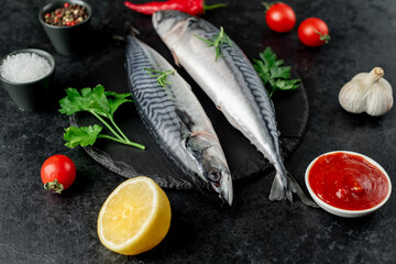 raw mackerel with spices on a stone background