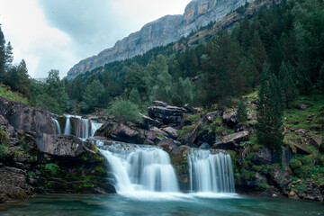 Fototapeta na wymiar The waterfalls of the Gradas de Soaso of the Arazas river in the National Park of Ordesa and Monte Perdido in the Pyrenees of Huesca. Aragon. Spain