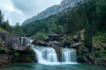 Fototapeta na wymiar Long exposure of the Gradas De Soaso waterfall on the Arazas river during the summer, Ordesa National Park, Huesca, Spain.