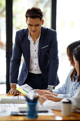Presentation. Young confident successful business Asian people discuss and analyze work, statistics, plans, presentations, startups in a meeting room. Teamwork. 