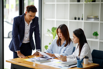 Presentation. Young confident successful business Asian people discuss and analyze work, statistics, plans, presentations, startups in a meeting room. Teamwork. 