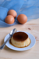 Homemade egg custard on wooden table