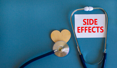 Side effects symbol. White card with words Side effects, beautiful blue background, wooden heart...