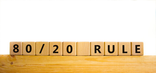 80 on 20 rule symbol. Wooden cubes with words '80 on 20 rule'. Beautiful wooden table, white...